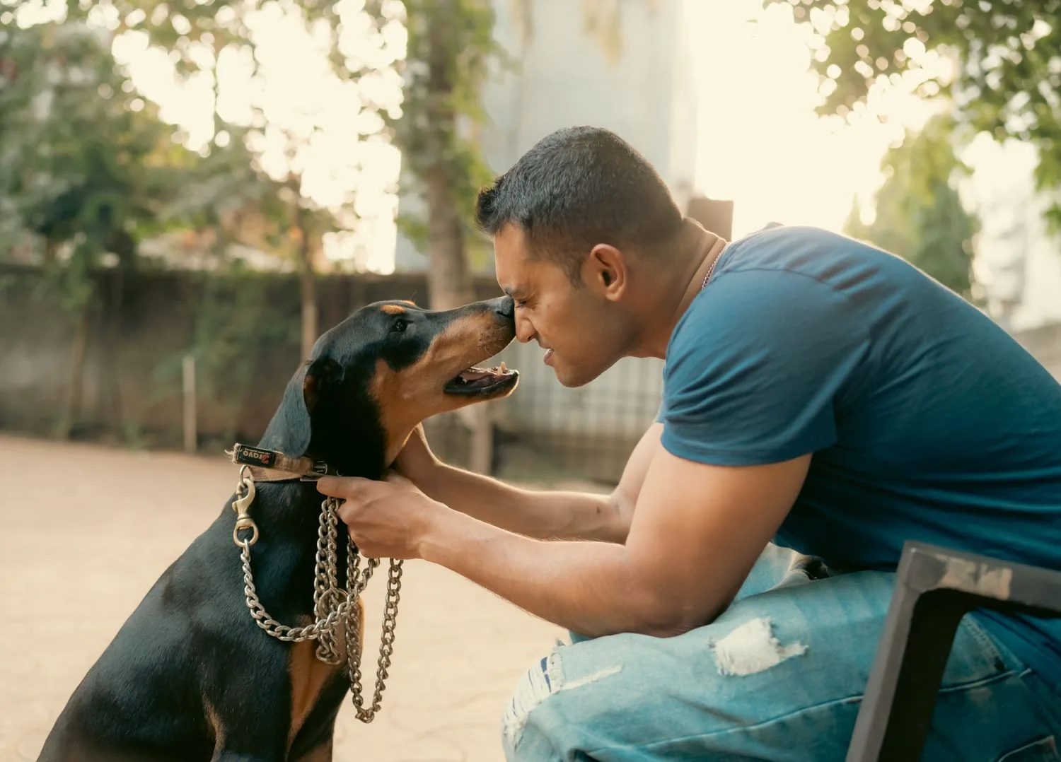 A man sharing a quiet, trusting moment with his dog outdoors